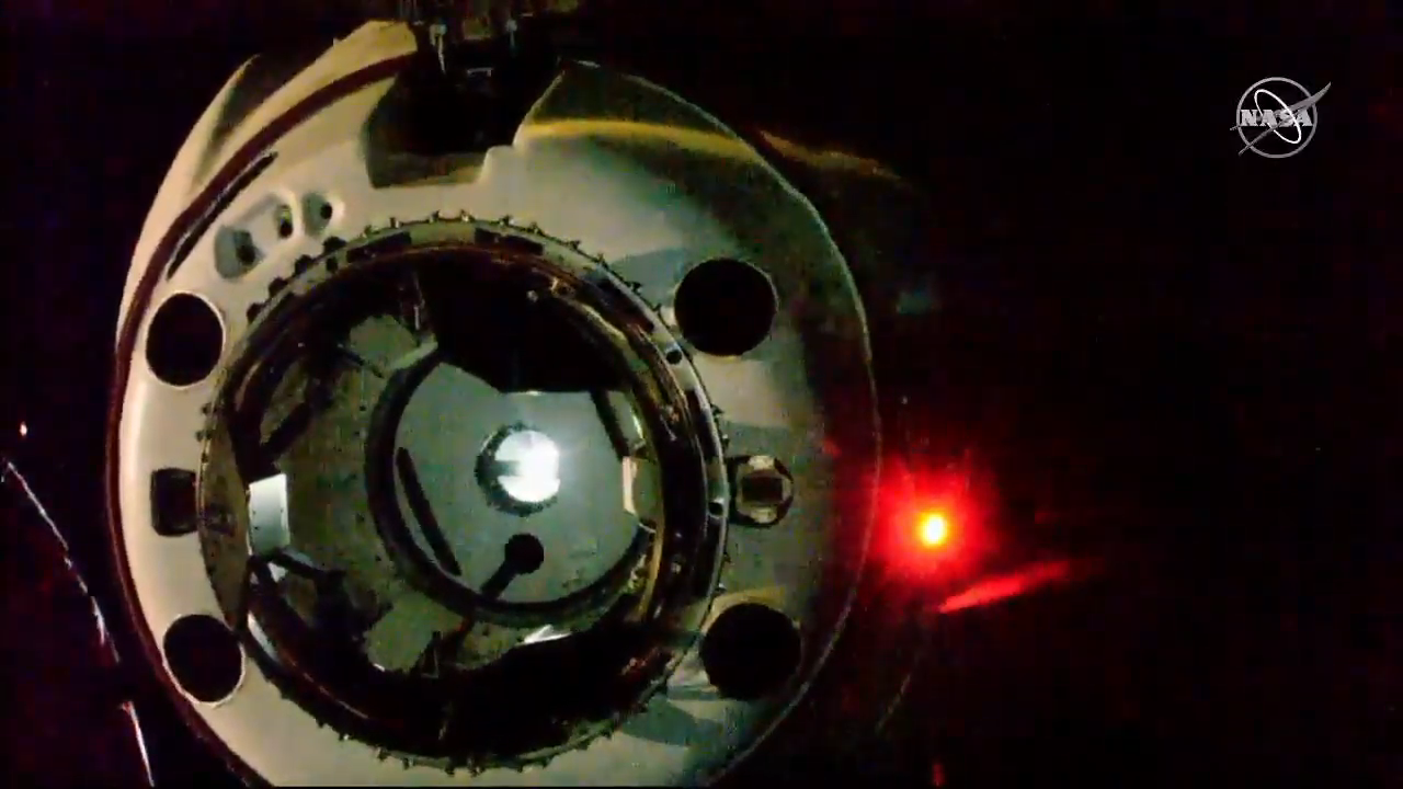 A close look at SpaceX's Crew Dragon moments first its historic first docking at the International Space Station on March 3, 2019. Light from its interior is visible through a small window in the hatch.
