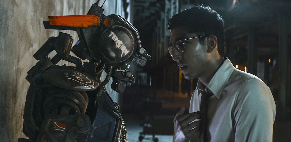 The &quot;feeling&quot; robot Chappie and his maker, Deon, face off in the film.