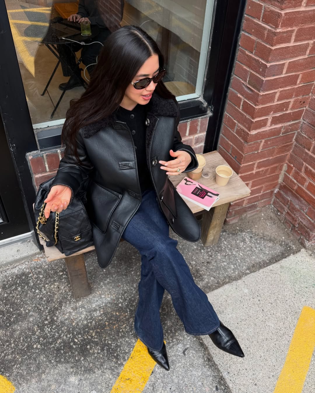 Sasha in dark wash jeans and black leather jacket