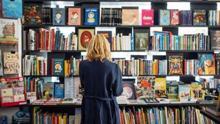 How to Sell books online - woman looking at books in a store
