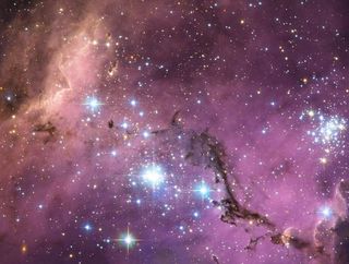 Nearly 200,000 light-years from Earth, the Large Magellanic Cloud, a satellite galaxy of the Milky Way, floats in space, in a long and slow dance around our galaxy. Vast clouds of gas within it slowly collapse to form new stars. In turn, these light up the gas clouds in a riot of colors, visible in this image from the Hubble Space Telescope.