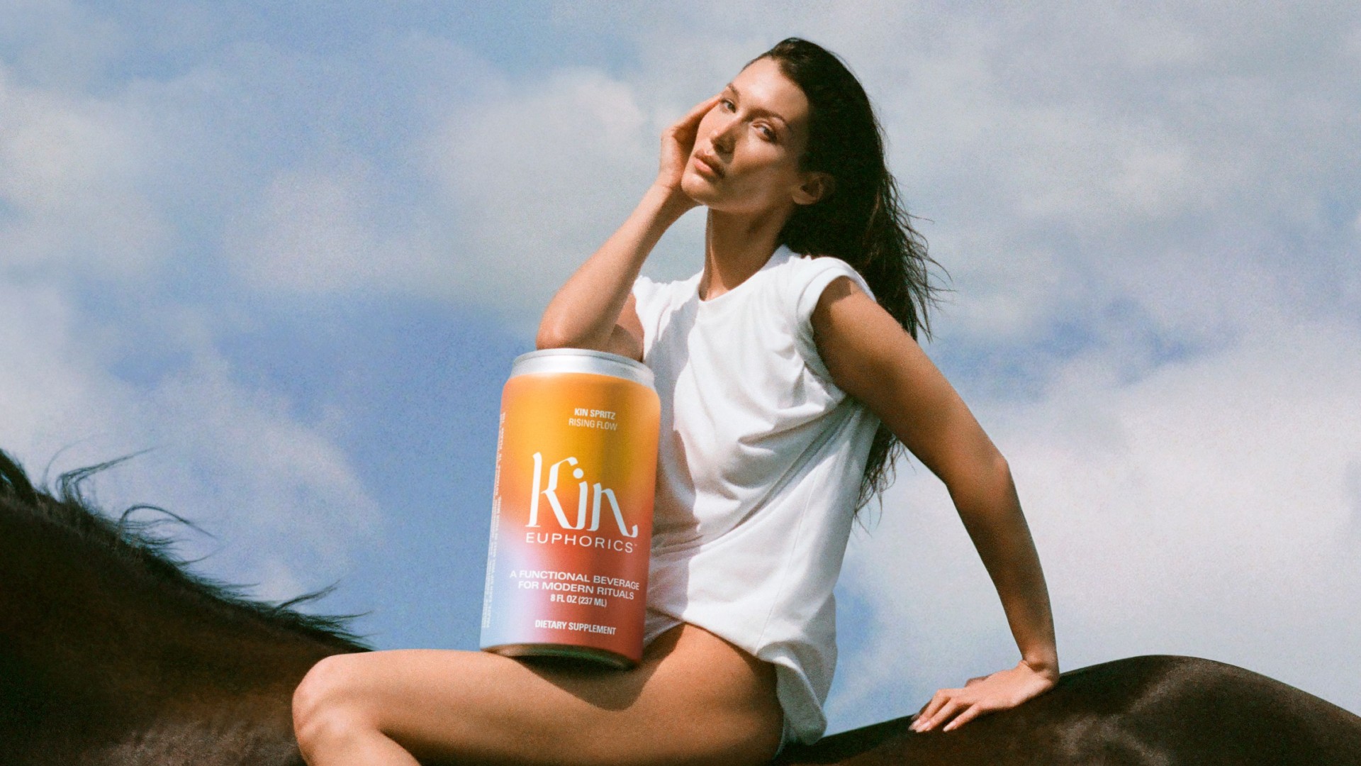 Picture of Bella Hadid sitting on a horse with a can of Kin Euphorics drink superimposed over the image