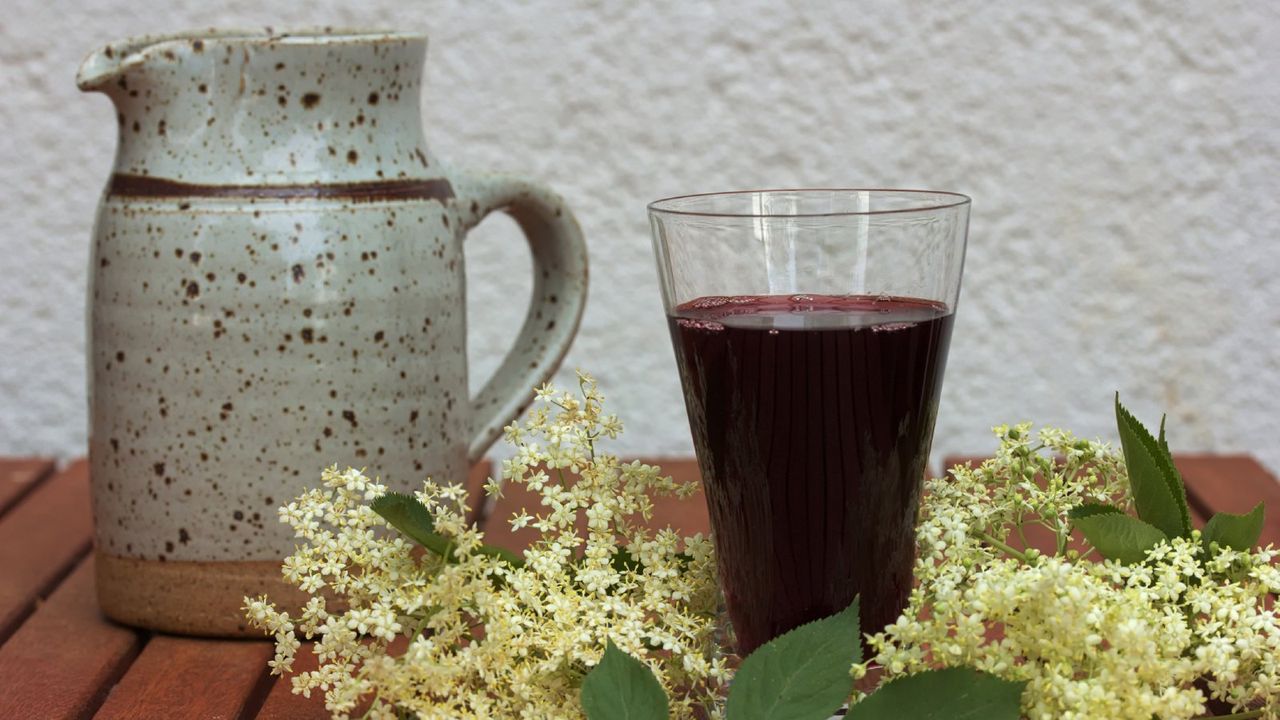 elderberry juice on table with flowers