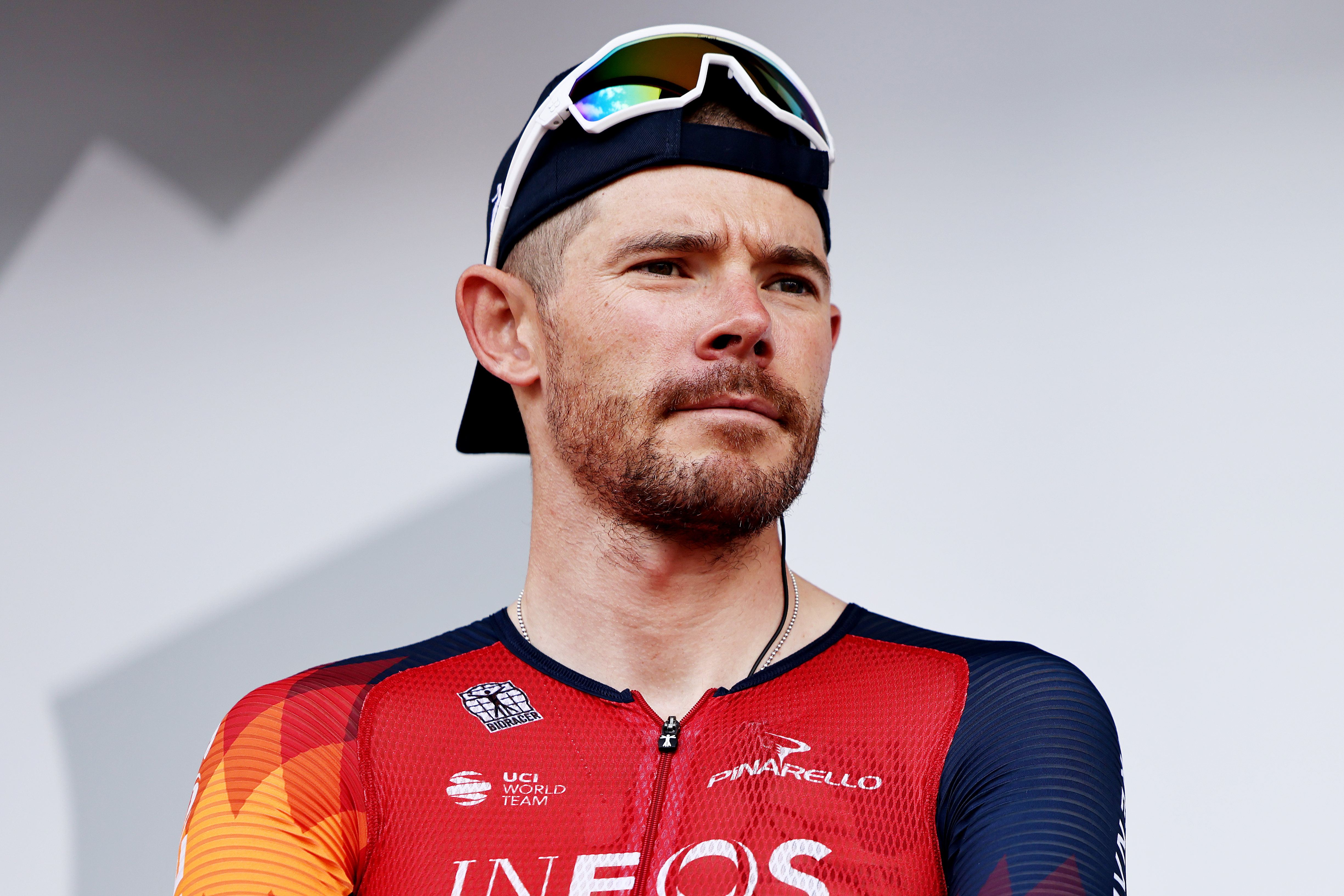 Luke Rowe, in a cap, sunglasses and Ineos jersey in 2023