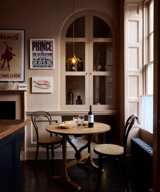 A plaster pink kitchen nook decorated with contemporary artworks