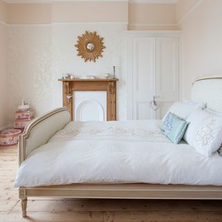 main bedroom with white walls and bed with pillows