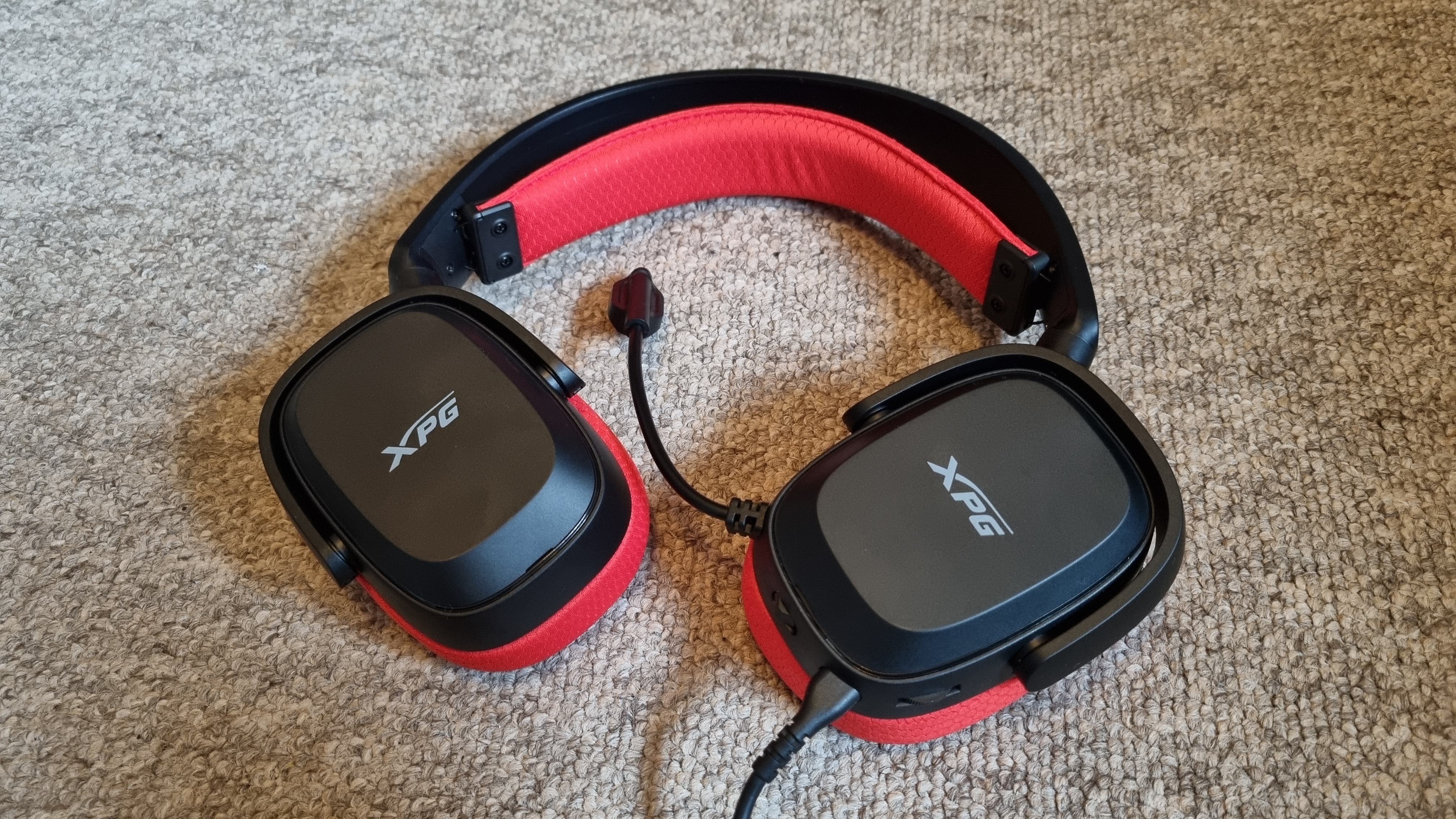 The XPG Precog Studio gaming headset with its earcups flat to the floor. Carpet, actually.