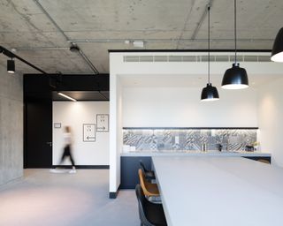 Concrete and crisp white surfaces meet at The Frames co-working space by Squire And Partners
