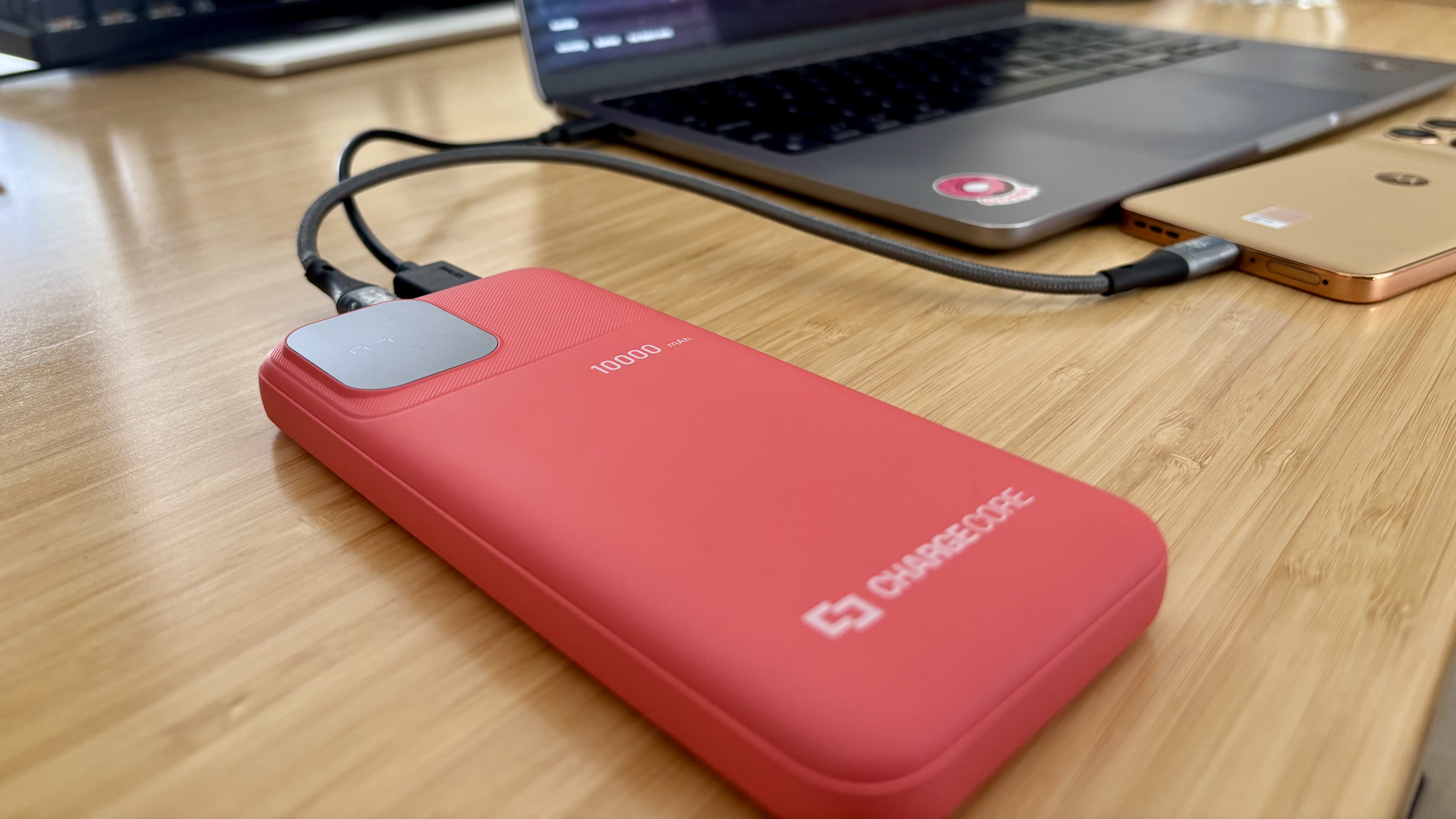 Laser ChargeCore 10K power bank charging a laptop and phone
