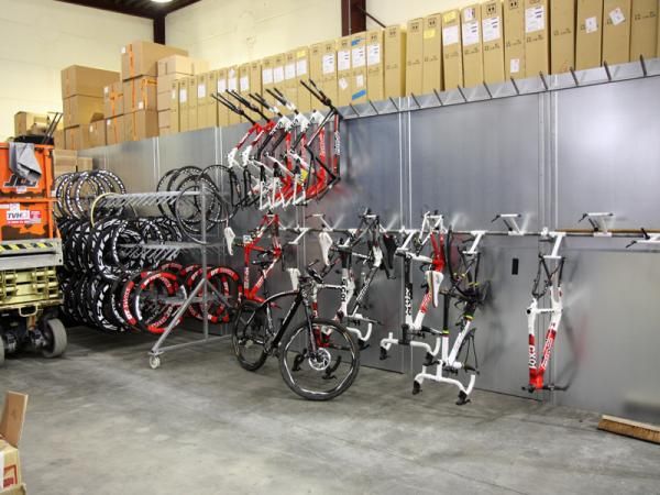 This corner of the service course included a rack for discontinued bikes and framesets and a portable rack specifically for time trial wheels. Tucked behind the wall is the storage area for new components while sitting up top is an army of new wheels and tires.