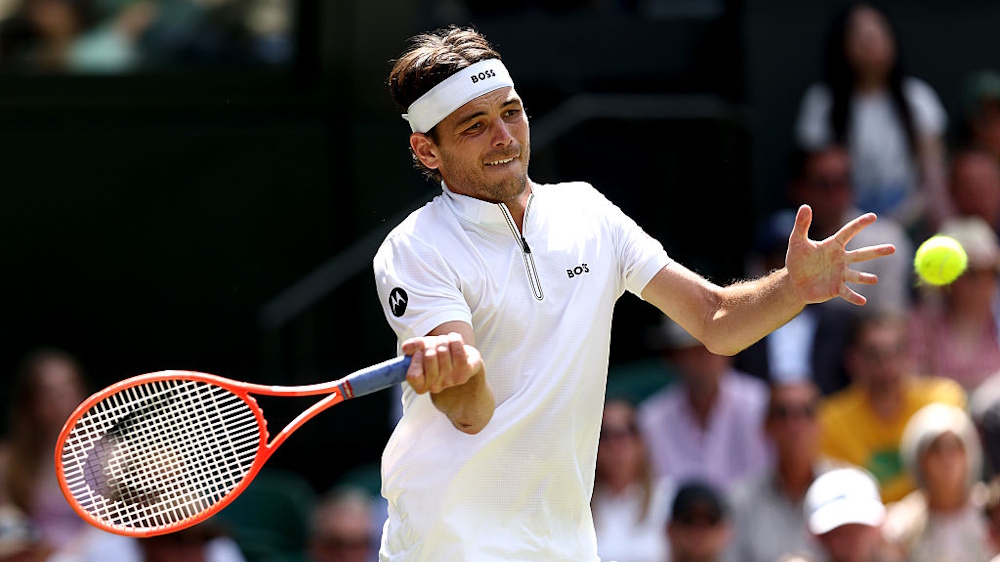 Taylor Fritz playing a forehand at Wimbledon.