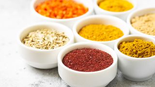 Bowls of fresh ground brightly colored spices