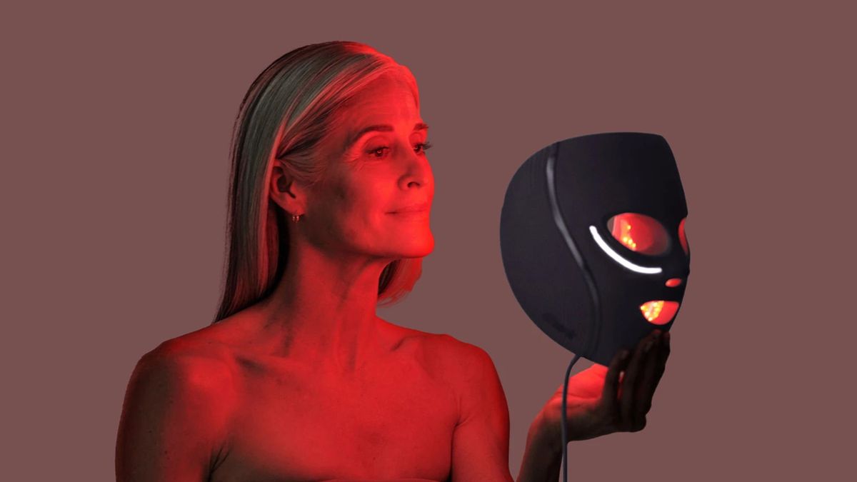 A woman using the Shark CryoGlow lit up in red