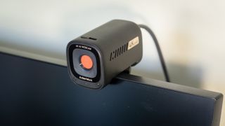 AnkerWork C310 webcam mounted on top of a monitor screen
