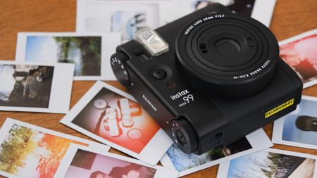 Fujifilm Instax Mini 99 surrounded by Instax Mini prints