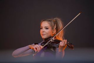 A picture of American Violinist, Lindsey Stirling performing onstage during the Lollapalooza Paris Festival in 2023
