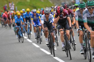 Egan Bernal sits on the wheels before his attack