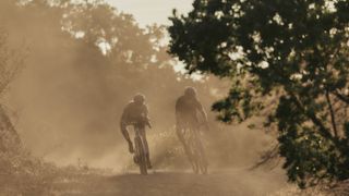 Gravel riders riding a dust gravel track