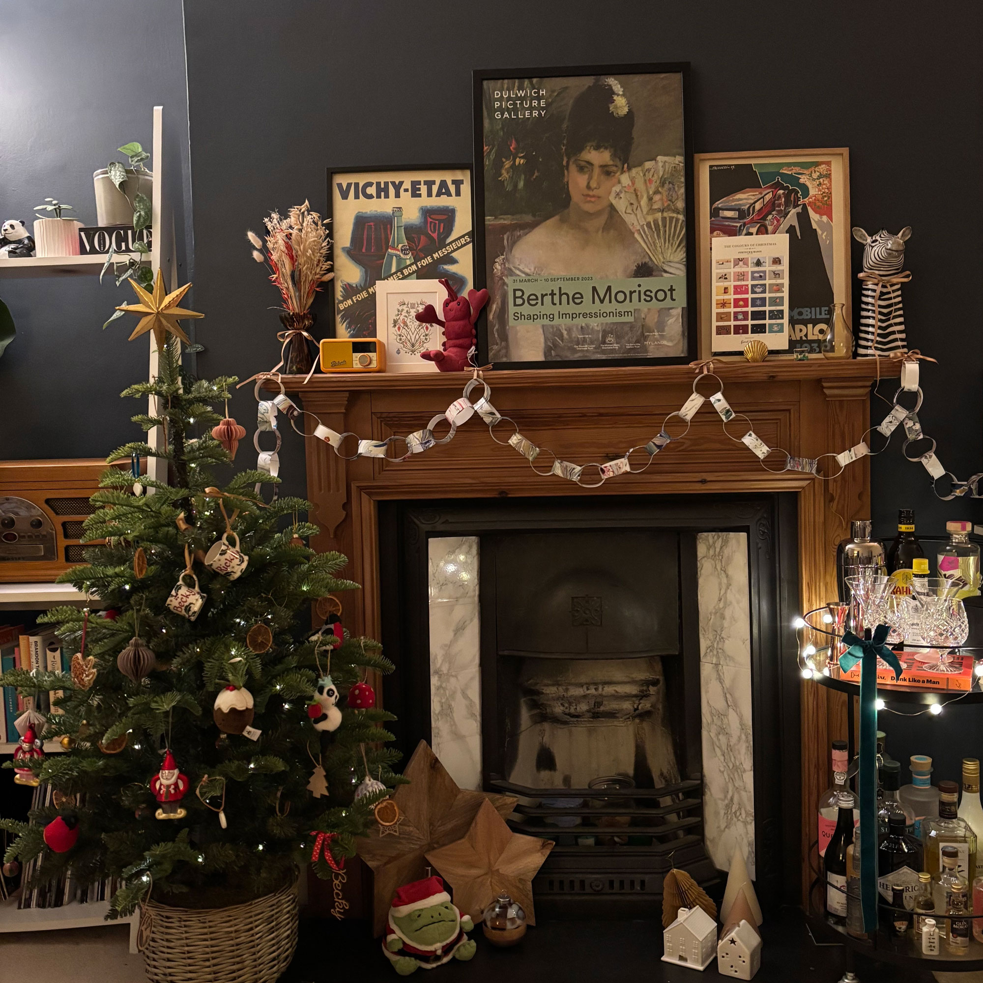 The White Company mini christmas tree infront of a fireplace with wooden stars and paper chain