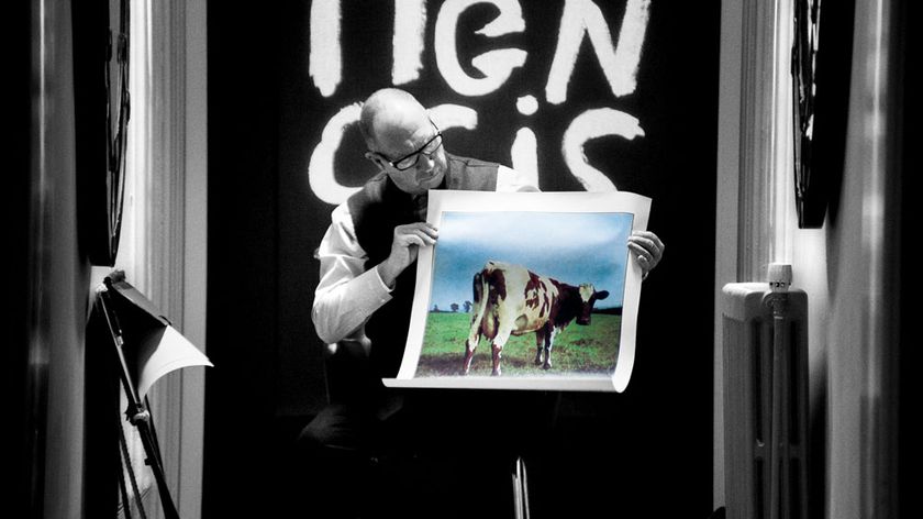 Squaring the circle doc still - man holding photo of cow