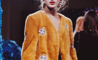 Model wearing a furry orange coat