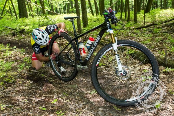 Justin Lindine with an early mechanical at the bottom of the first enduro segment.