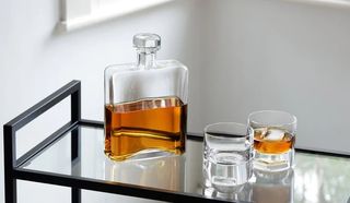 whisky decanter and two glasses on drinks trolley