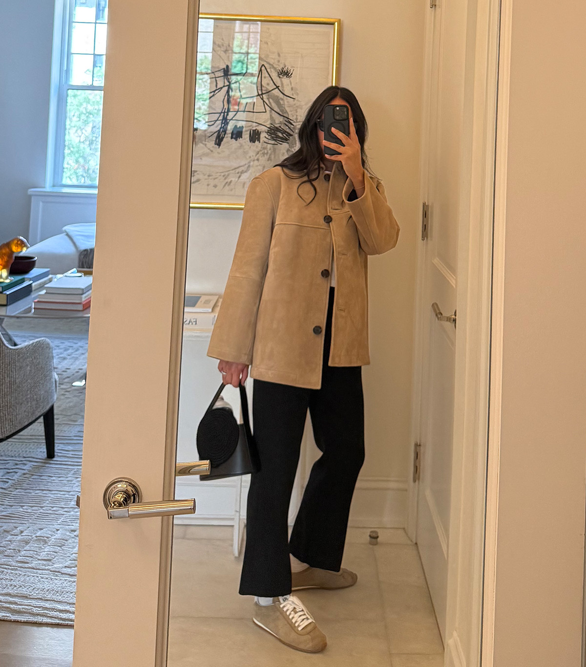 @nicoleakhtarzad taking a mirror selfie wearing a winter outfit.