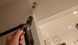 holding the wand up high with the hoover hl5