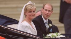 Prince Edward and Duchess Sophie leave in an open carriage following their wedding at St. George's Chapel on June 19, 1999