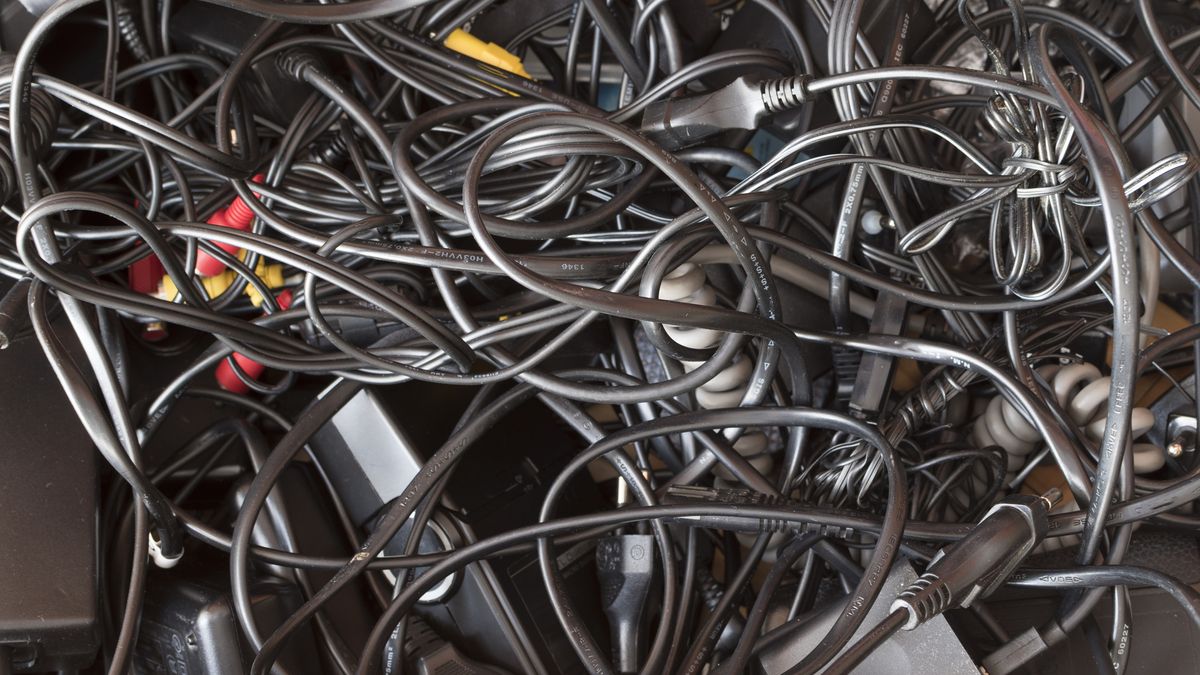 Messy drawer full of wires and cables in a complete disorder