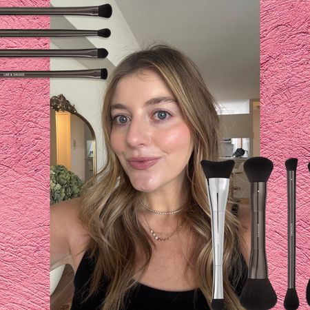 samantha holender with her makeup done on a pink background next to a set of makeup brushes