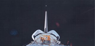 An Orbital Debris Calibration Sphere, or ODERACS, is deployed from the space shuttle Discovery during the STS-63 shuttle mission in February 1995.