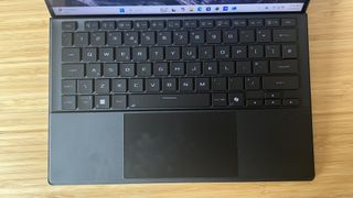 Keyboard attachment for Asus ROG Flow Z13, connected to the tablet and sitting on a wooden desk