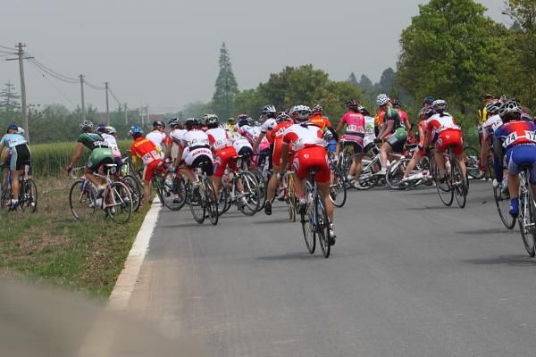 Riders divert onto the grass verges as a small crash has a domino effect on the road