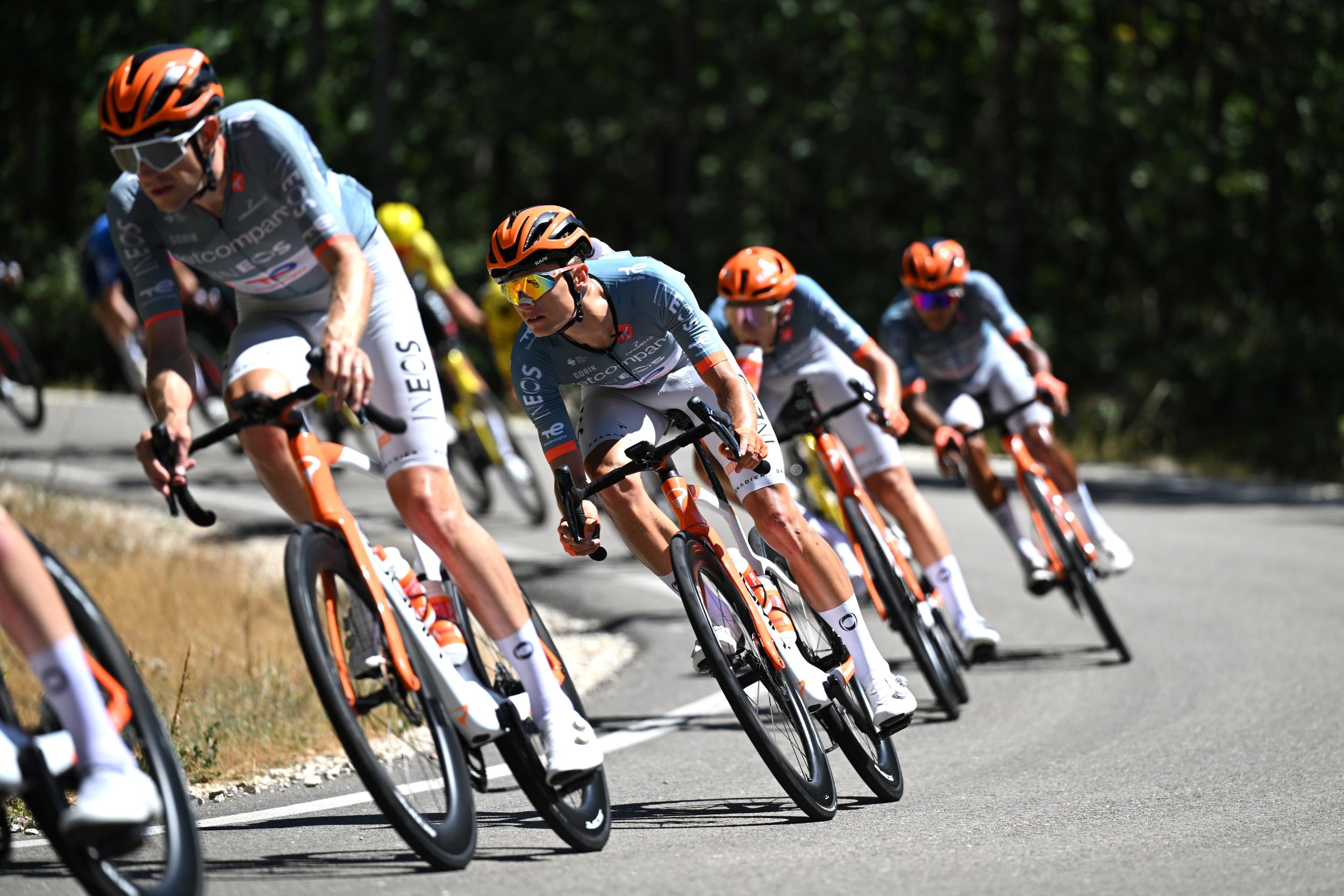 Oscar Onley in a line of Netcompany Ineos riders on a descent during a race in 2026