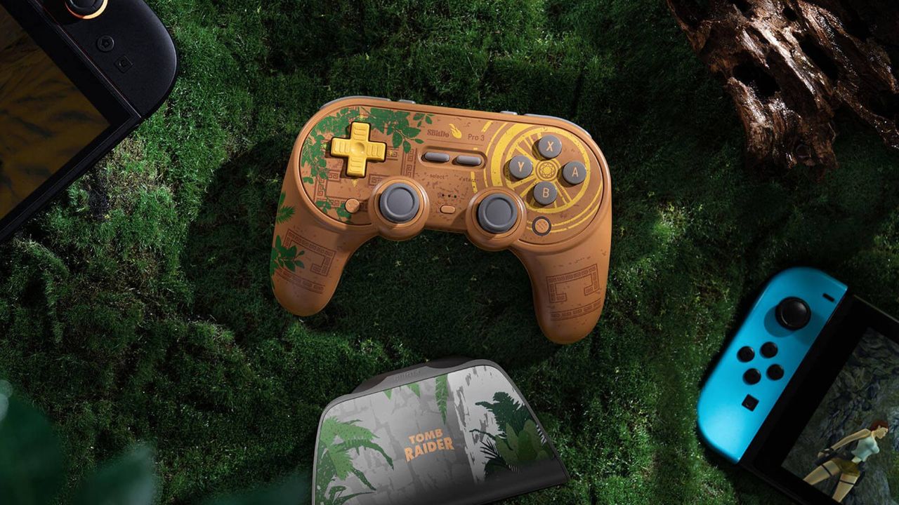 Photo of the 8BitDo Pro 3 Tomb Raider controller surrounded by handhelds.