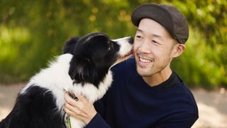 Japanese man and Border Collie relaxed outdoors