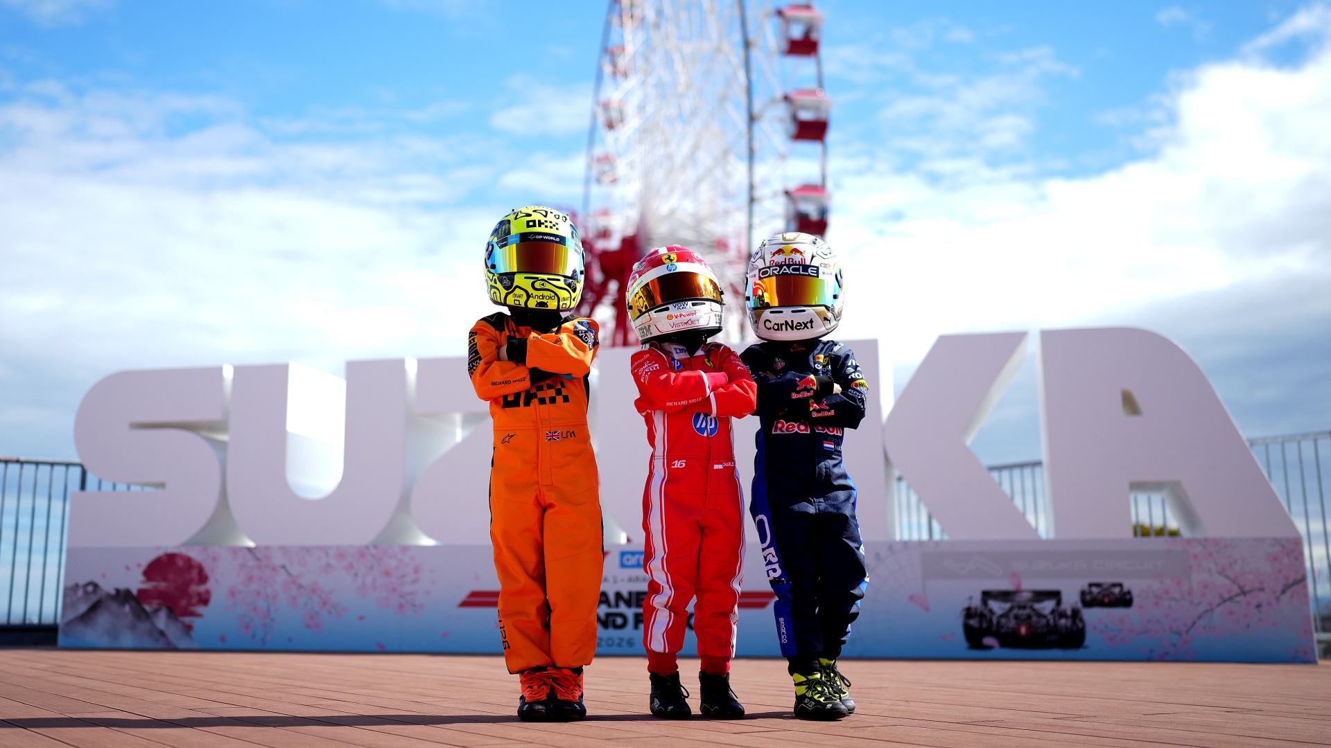 Young fans dressed as Lando Norris, Charles Leclerc and Max Verstappen at the 2026 Japanese Grand Prix