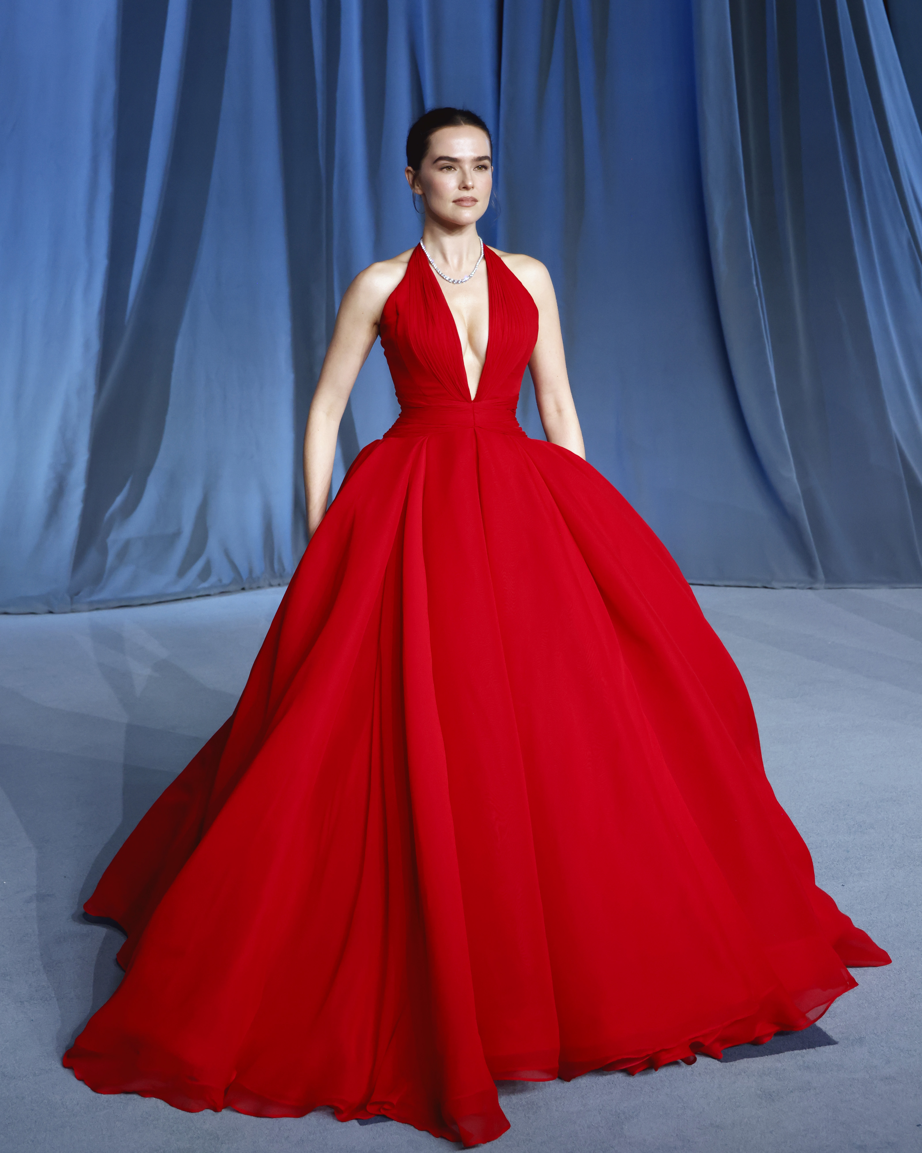 Zoey Deutch wearing a red dress by Zac Posen at the 2025 Academy Museum gala