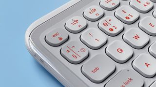 The Logitech POP Icon Keys keyboard against a blue background.