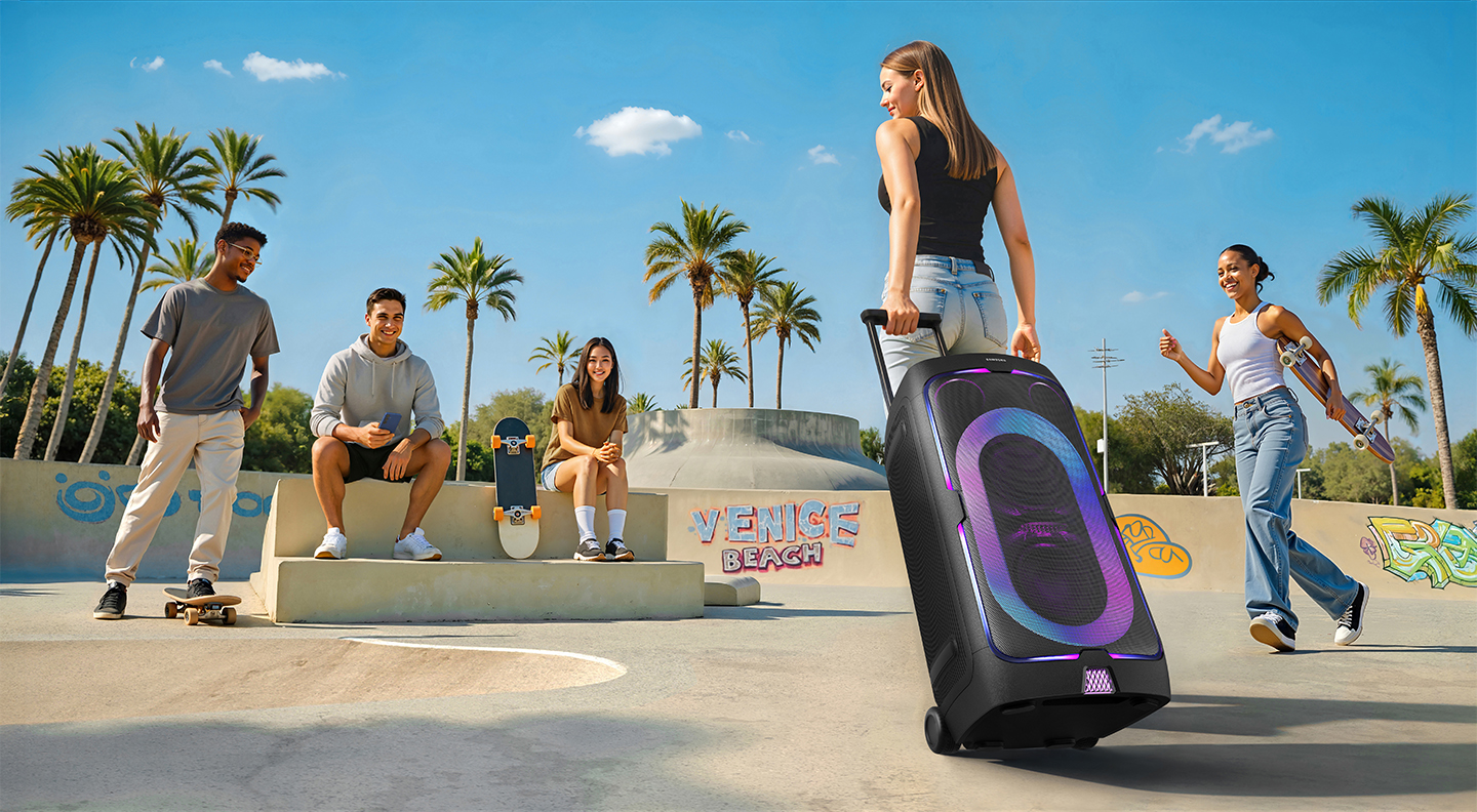 Samsung Sound Tower in a skate park with various good looking people around it. The words Venice Beach are sprayed on one of the upright bits of concrete
