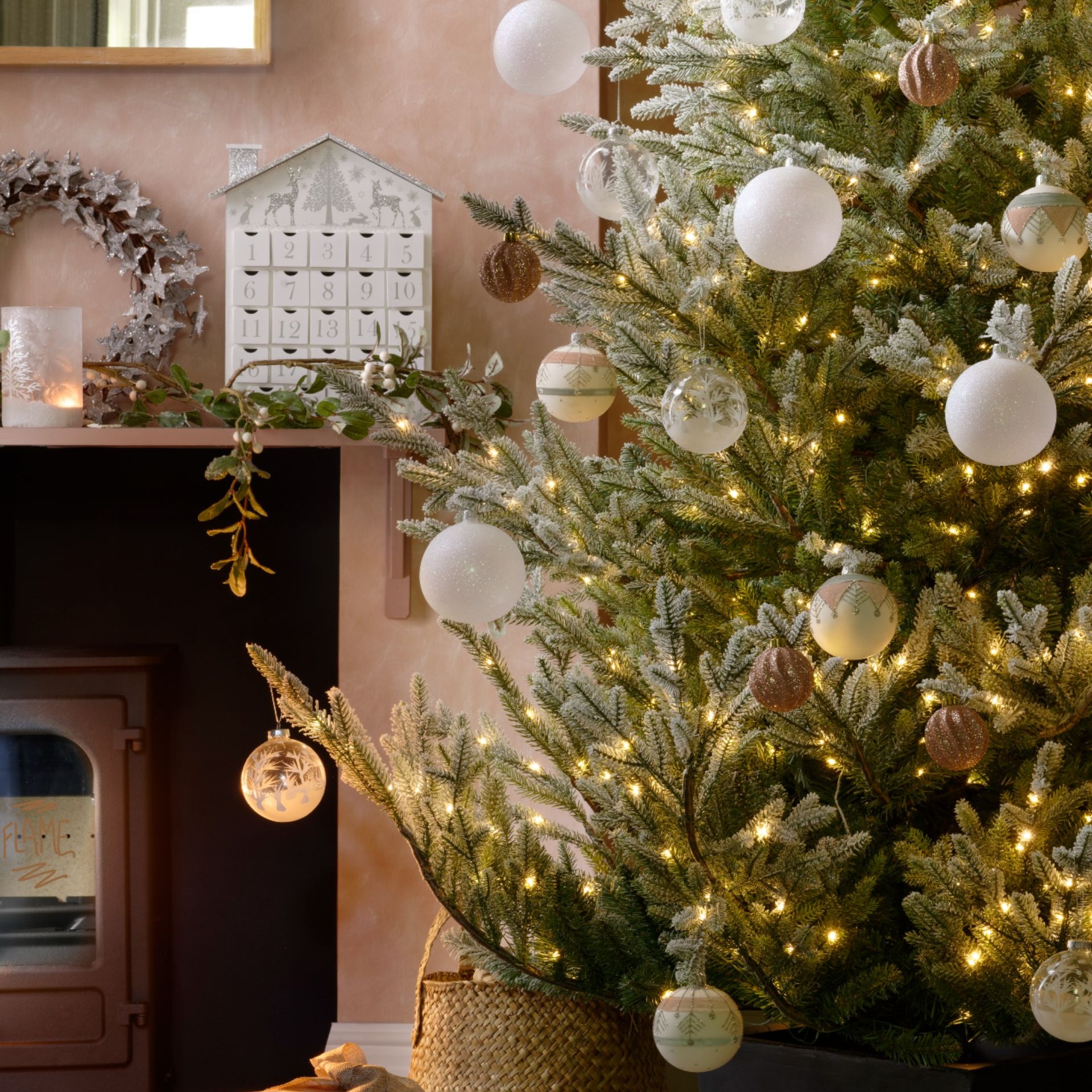 glittery bauble decorations on a Christmas tree inside a living room