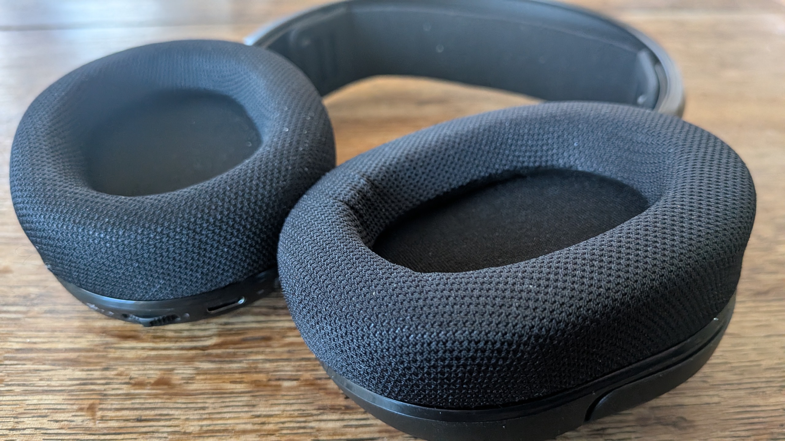 A gaming headset with its memory foam ear cups on display