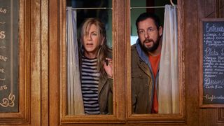 Audrey and Nick peer through a broken window in Murder Mystery 2
