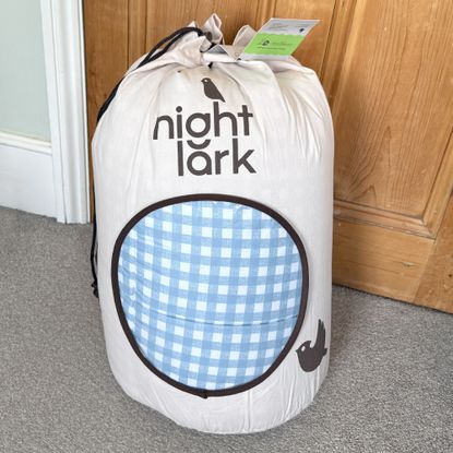The blue gingham Night Lark Coverless Duvet being tested at home