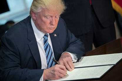 Trump signs a financial services Executive Order.