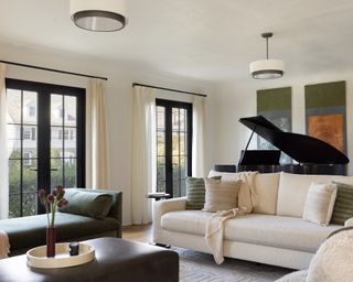 Living room with neutral sofa, chaise, coffee table and grand piano