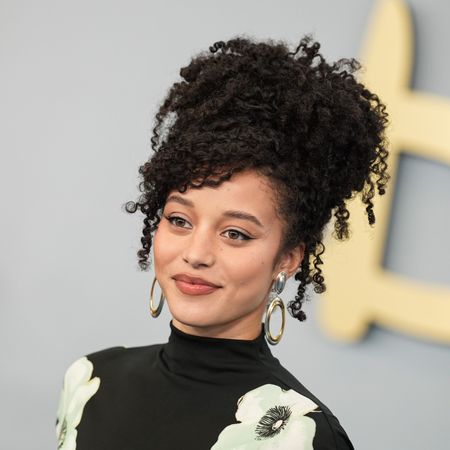 a young woman with dark, curly hair