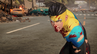 Mark from Invincible stands bloodied in a city street.